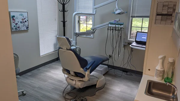 Dental exam tools and exam chair inside a treatment room